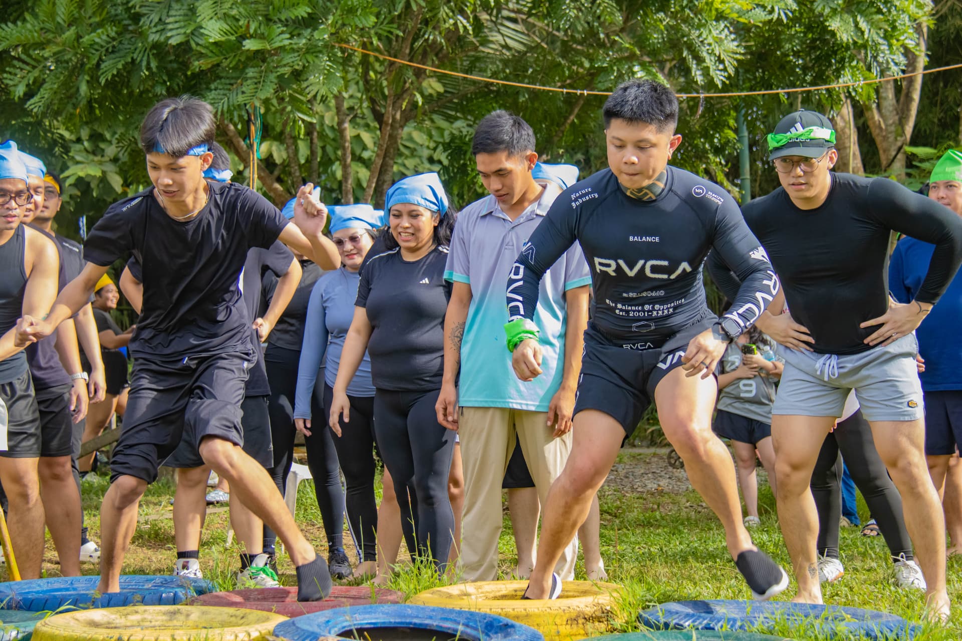 Teammates crossing the tire obstacle course