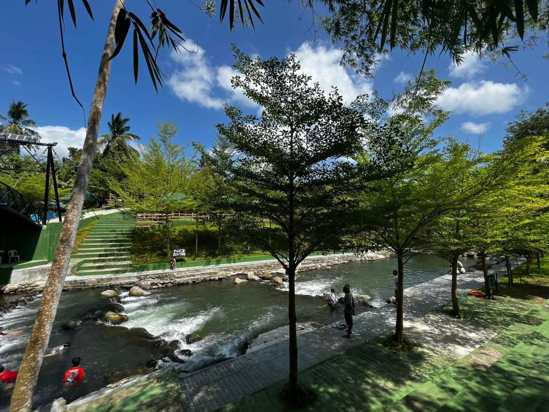 Rocky stream with walkways and green hillside steps